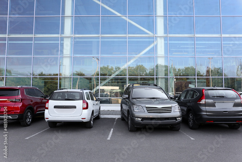 Cars parked in parking lot near business center in city © Pixel-Shot