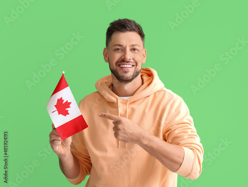 Happy young man pointing at...