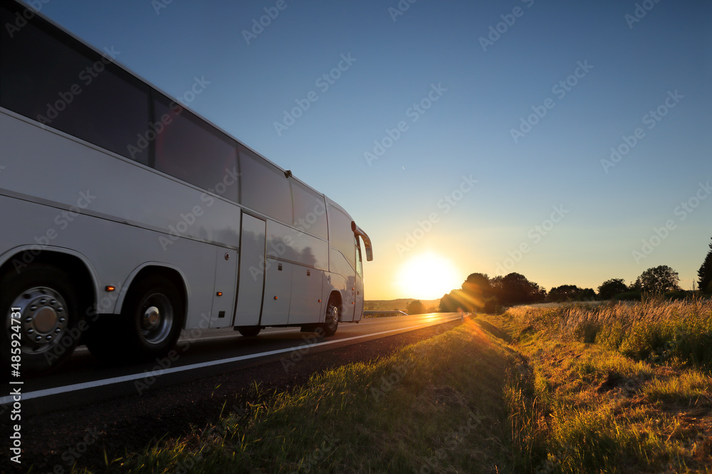 Bus with passengers on their way to vacation at sunset