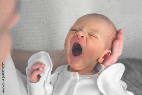 Newborn baby and young dad close up. Baby care concept, newborn weight, diapers, napkins, temperature, bilirubin. photo