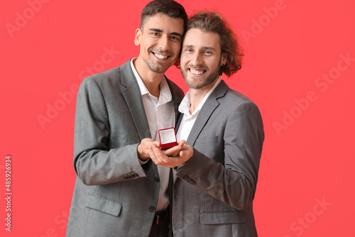 Happy engaged gay couple on...