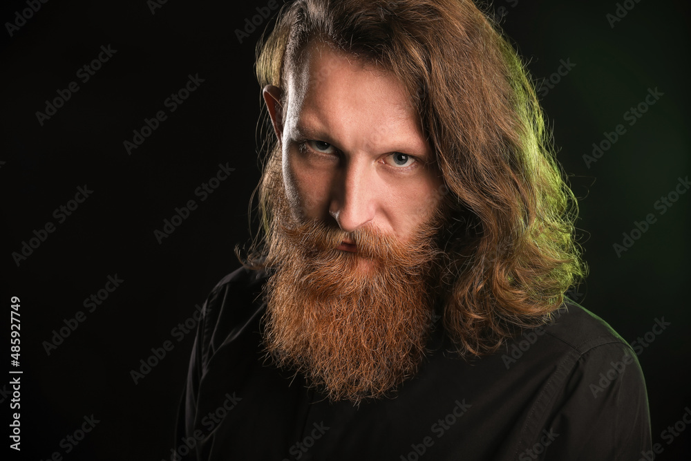 Fototapeta premium Portrait of young bearded man on black background