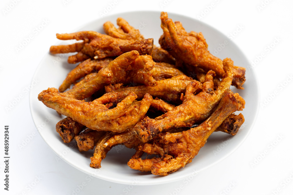 Fried chicken feet in plate on white background. Fried chicken feet in plate on white background.