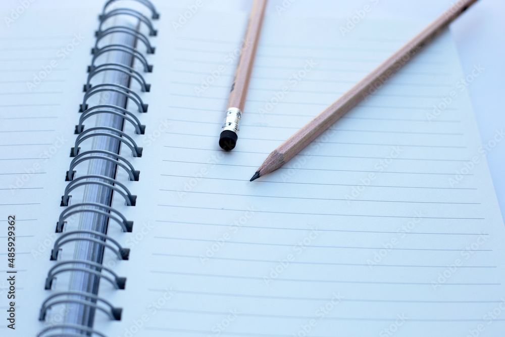 Pencils on notebooks or paper on white background Pencils on notebooks or paper on white background