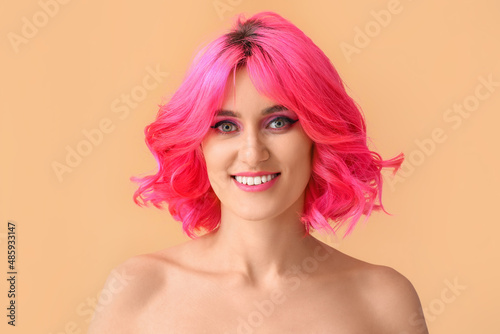 Stylish woman with bright hair on color background