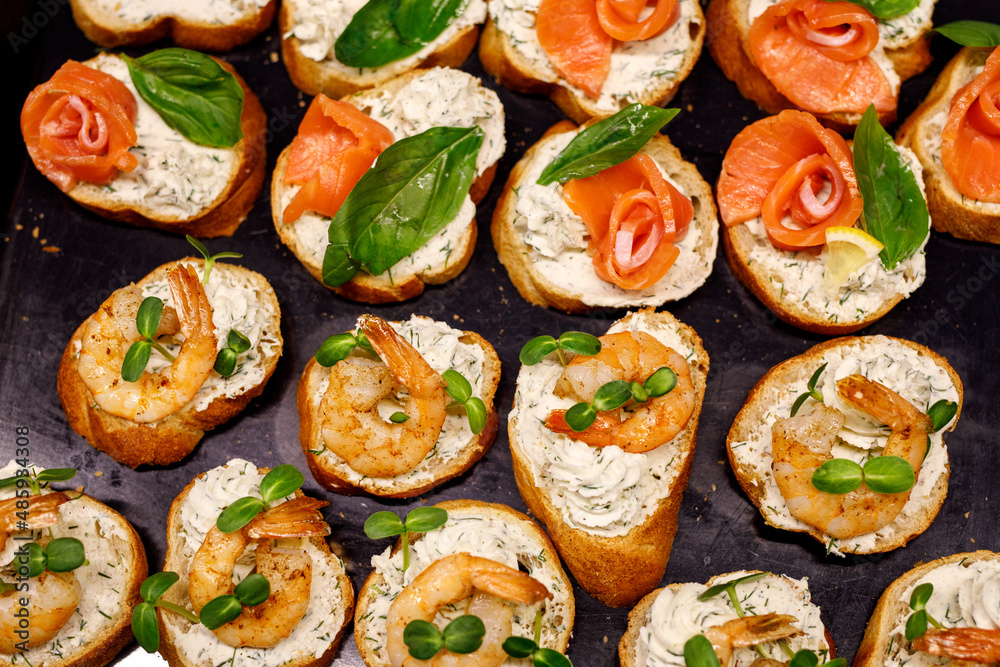 Top view of various Bruschettas with salmon and shrimps. Seafood sandwiches. Top view of various Bruschettas with salmon and shrimps. Seafood sandwiches.