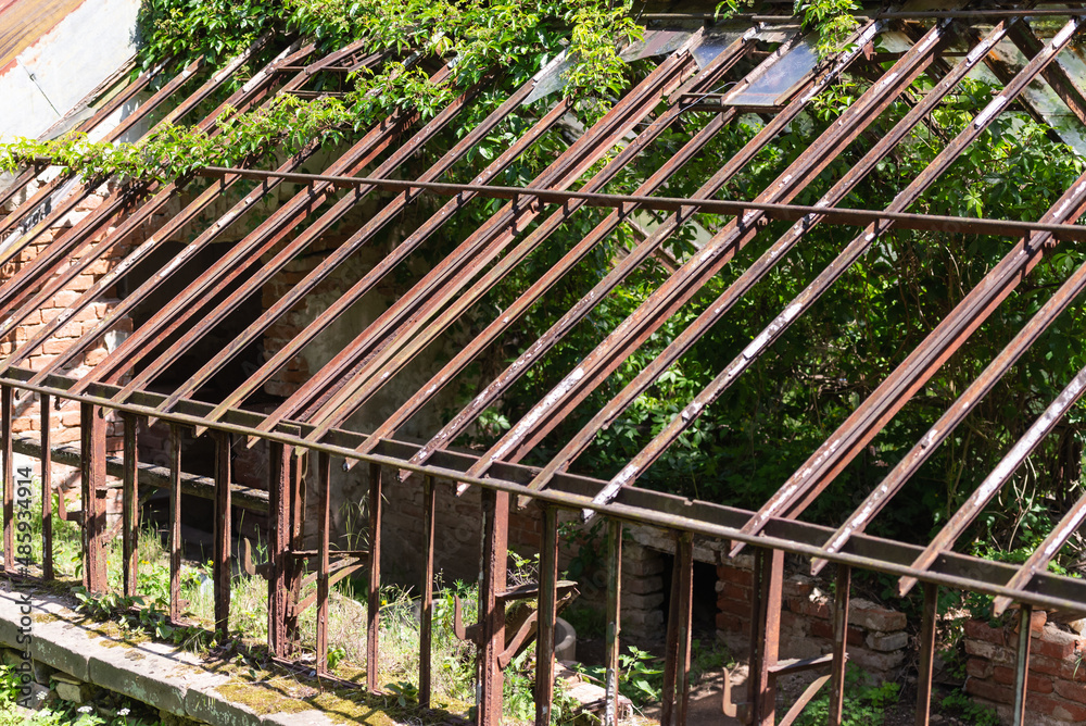 Ruins of an ancient greenhouse. The skeleton of an old heated greenhouse for growing vegetables.