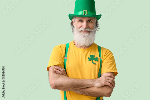 Senior man in green hat on ...