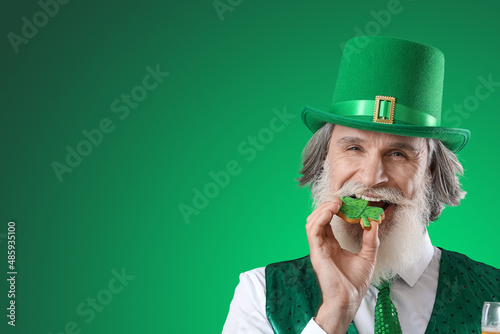 Senior man eating cookie on...