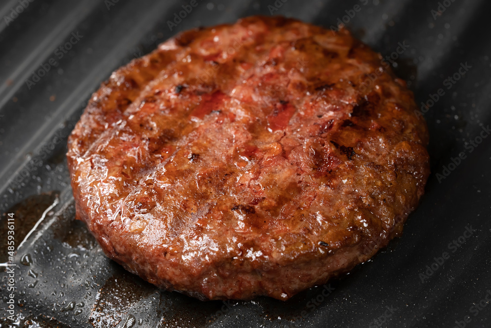 Process of roasting meat steak on barbecue grill plate. Cooking beef or pork patty. Raw cutlet for burger. Close-up photo. Process of roasting meat steak on barbecue grill plate. Cooking beef or pork patty. Raw cutlet for burger. Close-up photo.