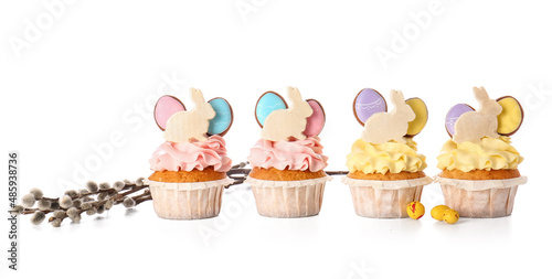 Tasty Easter cupcakes and willow branches on white background