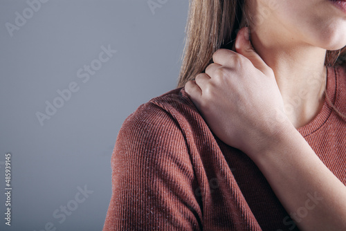 close-up on a woman's hand massaging her neck. Girl's neck hurts