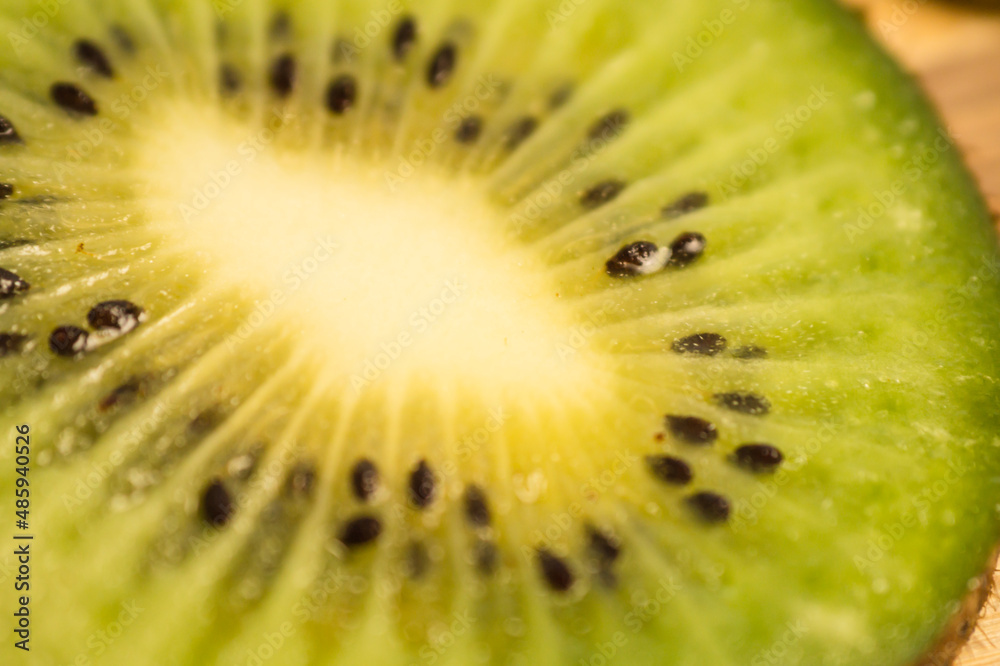 Fresh green kiwi cut into rings on a wooden background close-up. Fresh green kiwi cut into rings on a wooden background close-up.
