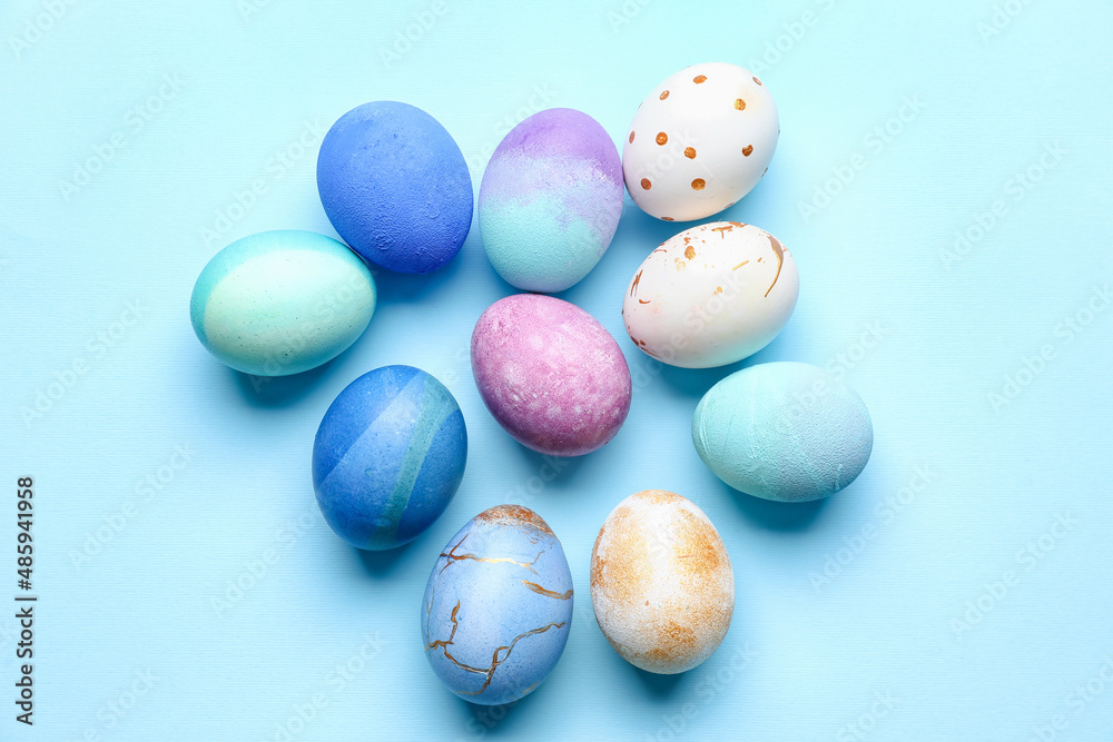 Many beautiful Easter eggs on blue background Many beautiful Easter eggs on blue background