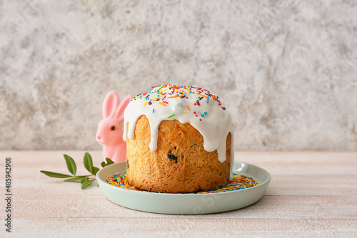 Plate with delicious Easter cake on table photo