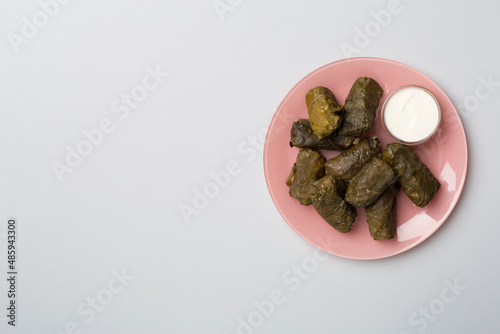 Delicious dolma served on wooden table background, top view photo