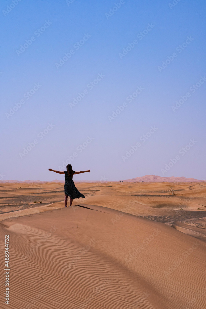 woman in long black dress, freedom in the desert