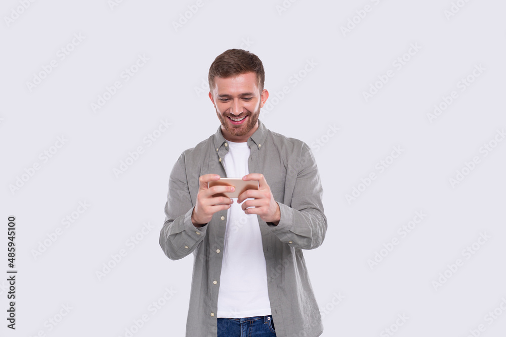 Man Playing Phone Games. Man Excited Playing Mobile games. Gamer Isolated Man Playing Phone Games. Man Excited Playing Mobile games. Gamer Isolated