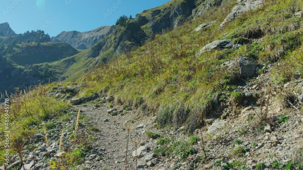 A mountain biker rides an exposed alpine trail A mountain biker rides an exposed alpine trail