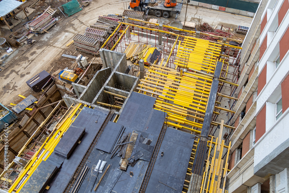 Preparation of the construction formwork for the cast concrete slab. Cast construction of high-rise buildings. Concrete work at a construction site. Cast-in-place concrete construction technology Preparation of the construction formwork for the cast concrete slab. Cast construction of high-rise buildings. Concrete work at a construction site. Cast-in-place concrete construction technology