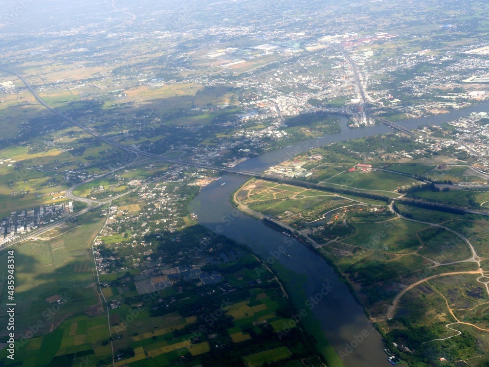 Aerial shot of farms and villages on the banks of Mekong Delta approaching Ho Chi Minh City, Vietnam. Aerial shot of farms and villages on the banks of Mekong Delta approaching Ho Chi Minh City, Vietnam.