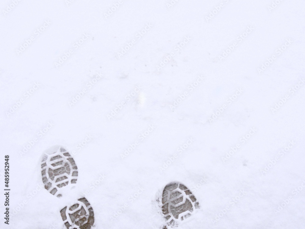 Big shoe prints in the pristine white snow