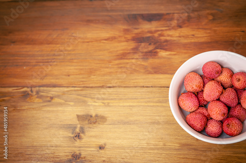 fresh organic lychee fruit and old wood background. Top view photo with copy space