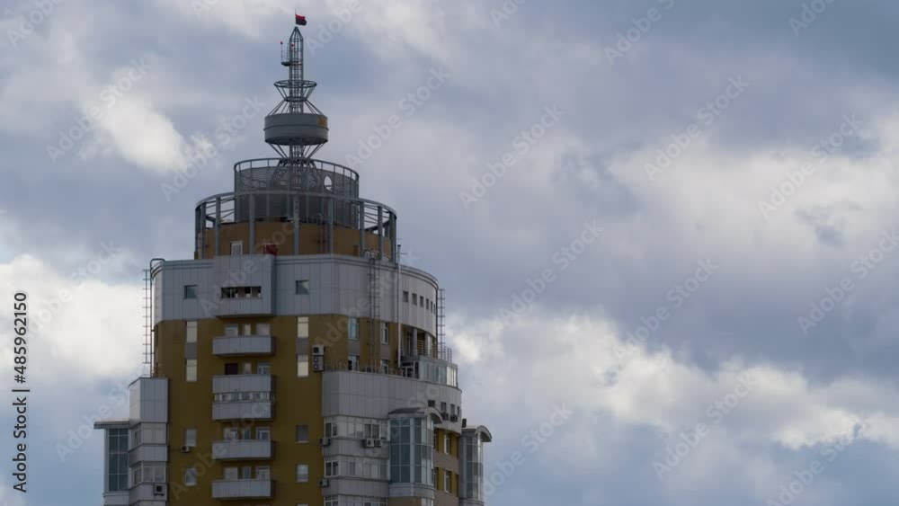 Building tower rooftop with metallic construction drone shot. Gray clouds moving Building tower rooftop with metallic construction drone shot. Gray clouds moving