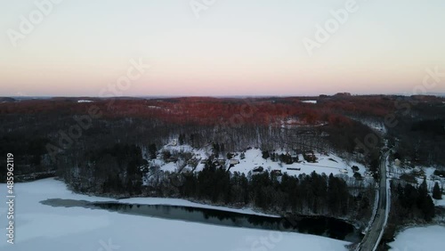 sunrise over the ice covered reservoir 