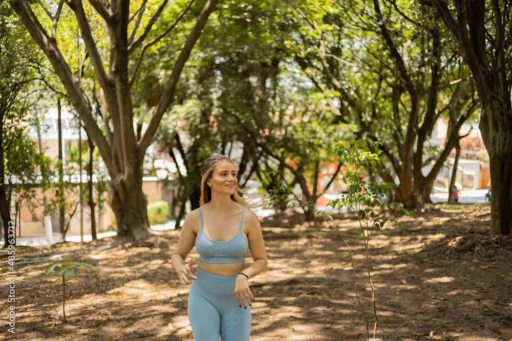 Young woman running and jogging at a park outdoors. Athlete female person during workout. High quality photo Young woman running and jogging at a park outdoors. Athlete female person during workout. High quality photo