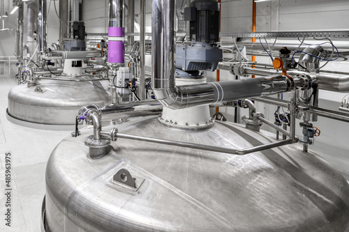 Large tank with processed aggressive liquids in workshop