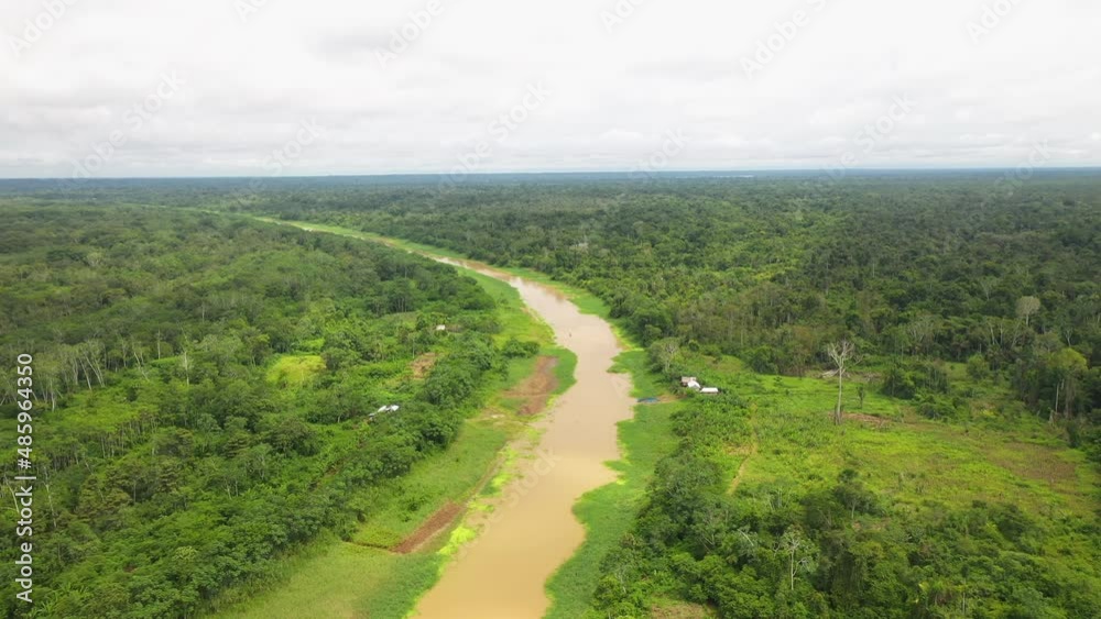 Wide rotating drone shot of the amazon river and the Amazon rainforest surrounding the water in Peru Wide rotating drone shot of the amazon river and the Amazon rainforest surrounding the water in Peru
