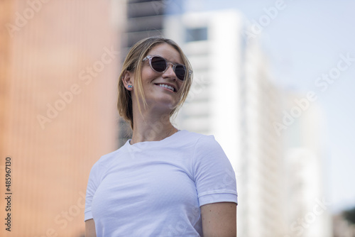 Portrait of a beautiful blonde woman  on a big city street on an urban background. High quality photo © Buonaventura