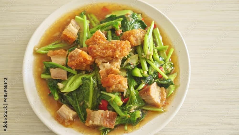 Stir-fried kale vegetable with crispy pork - Asian food style Stir-fried kale vegetable with crispy pork - Asian food style