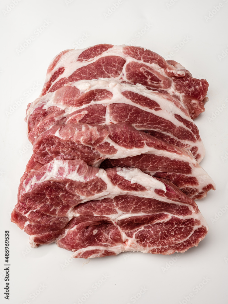 Close up of raw fresh pork steaks. marble beef. Group of fresh raw beef meat steak. Raw meat. fresh raw beef lamb. cooking meat on white. Butchery, market, shop Close up of raw fresh pork steaks. marble beef. Group of fresh raw beef meat steak. Raw meat. fresh raw beef lamb. cooking meat on white. Butchery, market, shop