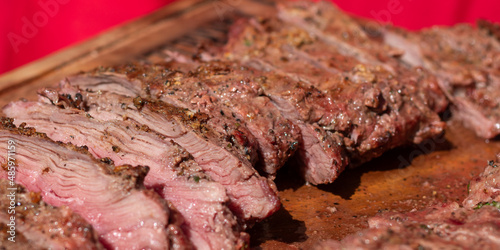 entraña de res asada, salpimentada
 y cortada en rebanadas.

carne de res.

carne en el asador. 

carne de res en el asador.
 photo