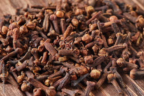 Dried spice herbs cloves for flavoring foods and natural medicines, Indian spice ingredient on wooden background