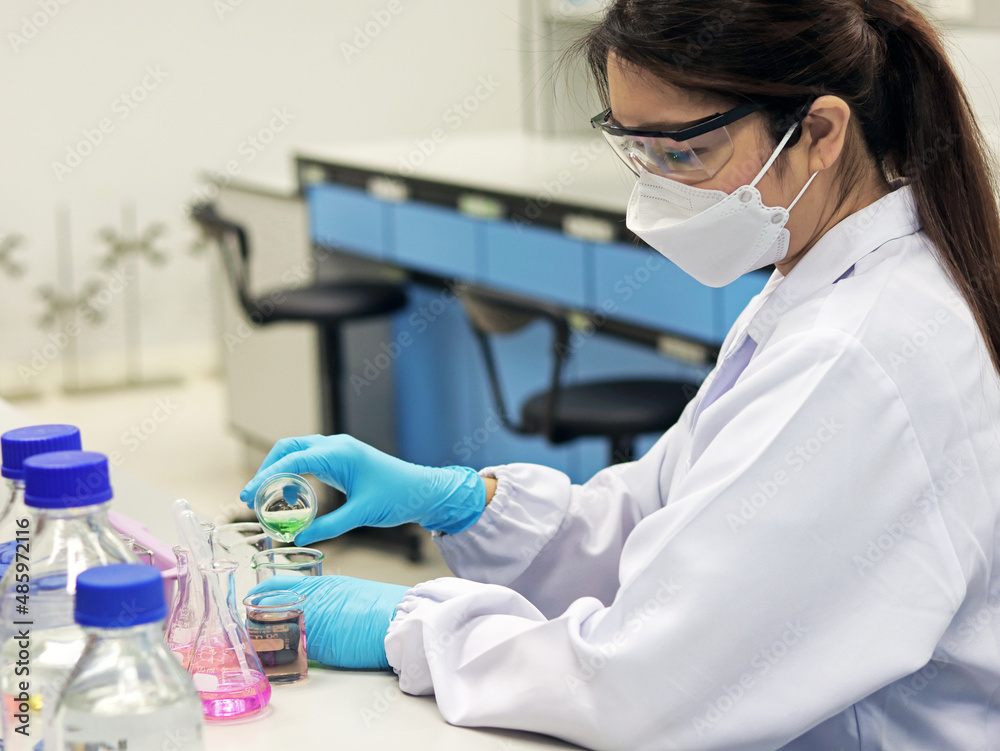 Plakat The scientist wears PPE do the chemical experiment in laboratory