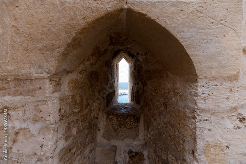 The Citadel of Qaitbay or the Fort of Qaitbay is a 15th-century defensive fortress located on the Mediterranean sea coast. Ordinary people walk nearby photo