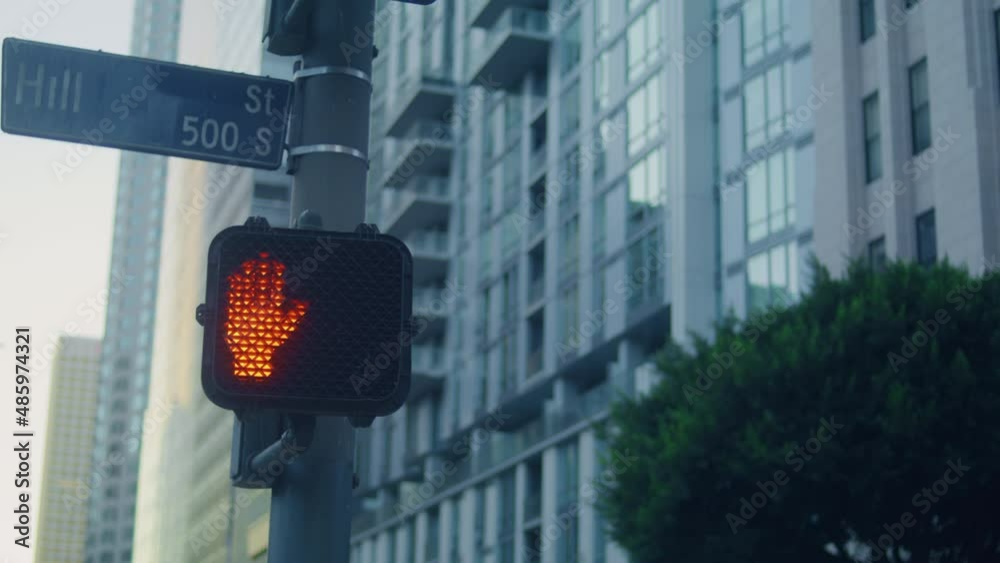 Stop signal pedestrian on road close up. Red hand up blinking on black screen.