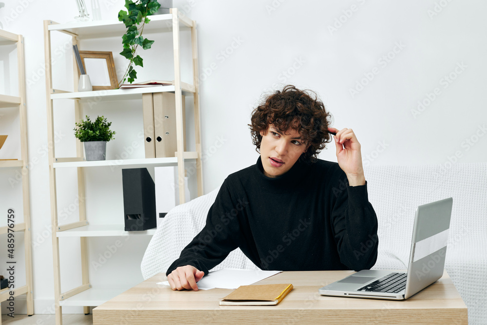 guy on a white sofa in front of a laptop learning living room guy on a white sofa in front of a laptop learning living room