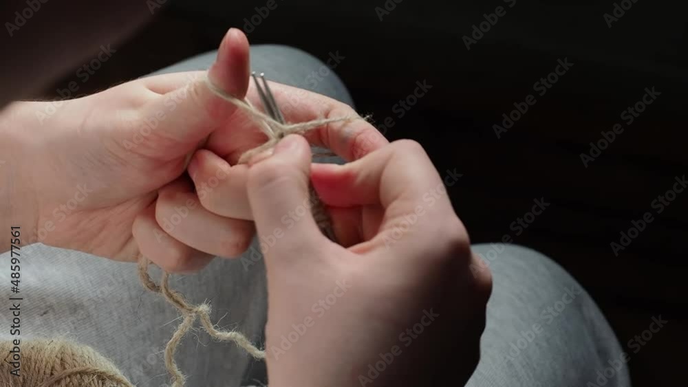The process of knitting with needles. The hands of a young girl knitting with needles. Handmade concept, hobby, relaxation. The process of knitting with needles. The hands of a young girl knitting with needles. Handmade concept, hobby, relaxation.