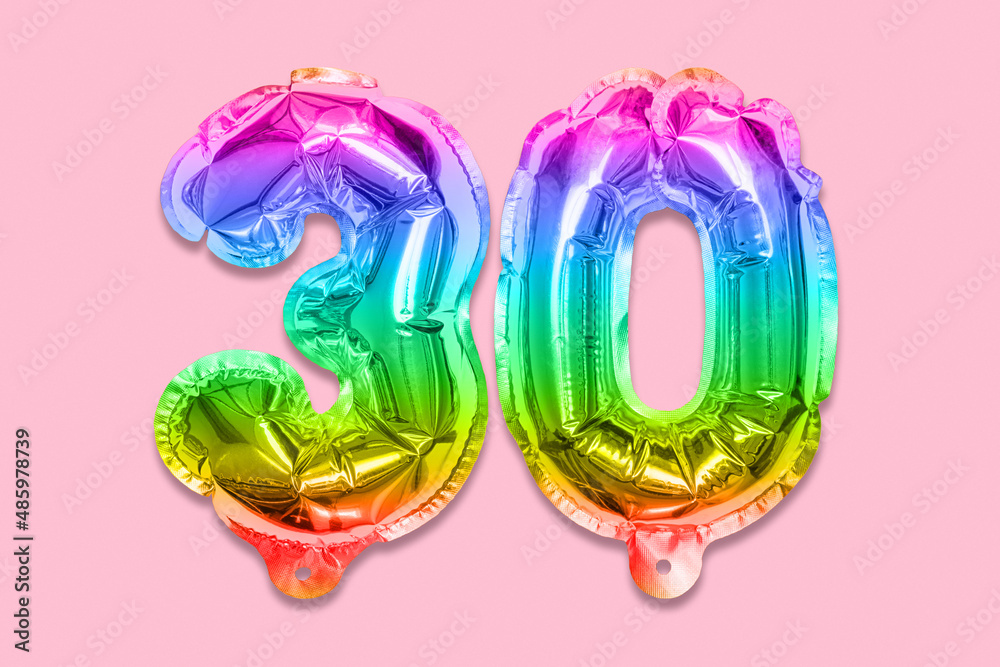 Rainbow foil balloon number, digit thirty on a pink background. Birthday greeting card with inscription 30. Anniversary concept. Top view. Numerical digit. Celebration event, template. Rainbow foil balloon number, digit thirty on a pink background. Birthday greeting card with inscription 30. Anniversary concept. Top view. Numerical digit. Celebration event, template.