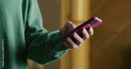 man's hand takes out a phone and types, then puts it away