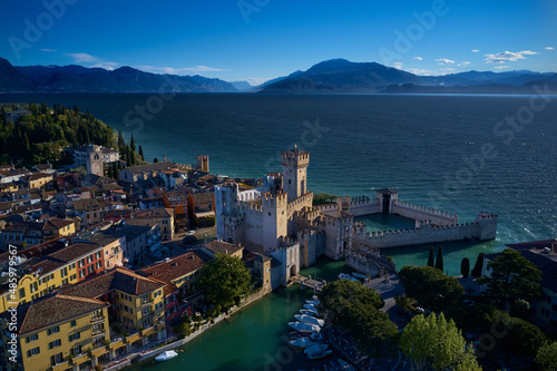 Aerial view of Sirmione. The flag of Italy on the main tower of the castle. Sirmione Castle, Lake Garda, Italy.