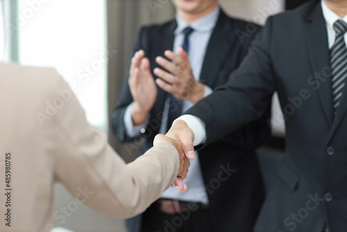 Close up image of business happy people shaking hands meaning of introduction, greeting, success negotiation or finishing up meeting. Gesturing connection deal concept.