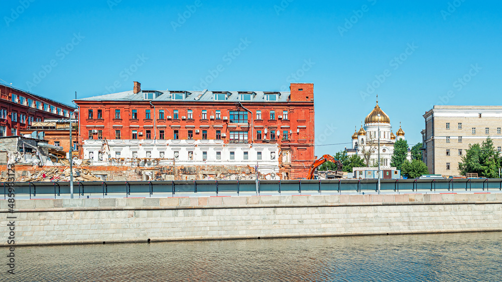 Dismantling a building on Bolotnaya Embankment in front of the Cathedral of Christ the Saviour in Moscow, Russia
