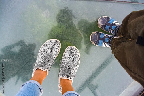 People standing on a glass bridge in the Caucasus Mountains. Georgia. 2019. Sataplia. photo