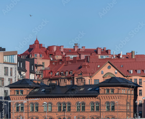 Red and black tin roofs on 1800s houses in the district Vasastan a winter day in Stockholm