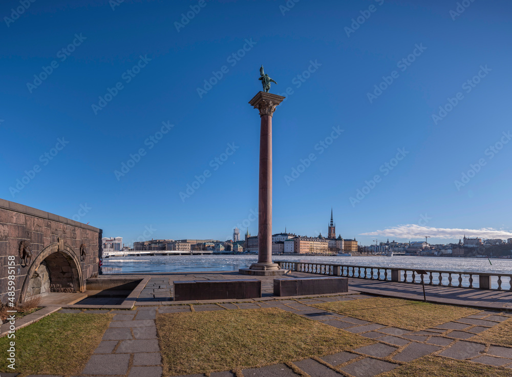 Obraz premium Panorama view, from the Town City Hall parterre with statue on a column capital and skyline of the government houses and the court houses on the island Riddarholmen, Stockholm